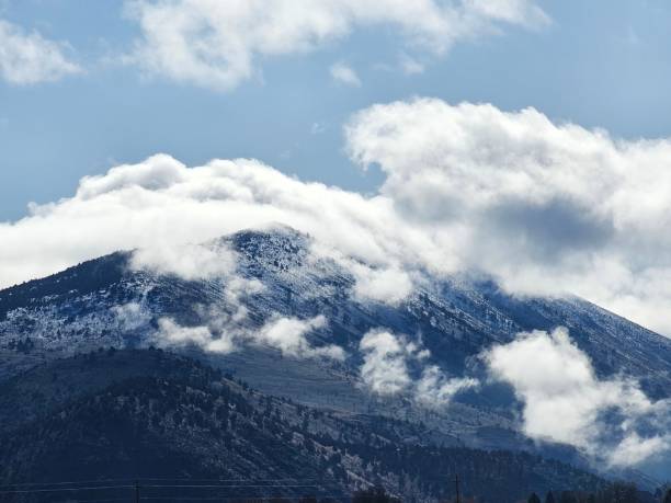 Snowy hill under cloudy sky