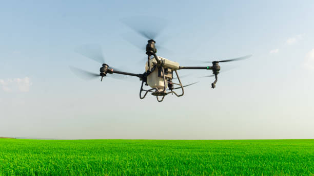 istock Agriculture drone fly to sprayed fertilizer on the  fields. smart farmer use drone for various fields like research analysis, terrain scanning technology, smart technology concept. 2050080094