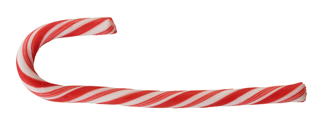 Bright red and white candy cane seen from the side and isolated for eating or decoration during the holiday.