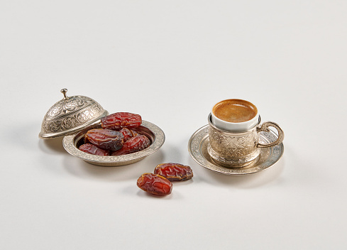 Ramadan date in the zinc plate turkish culture style with rosary and coffee.