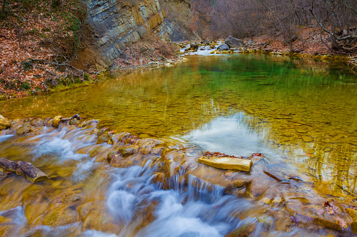 small mountain river rushing through the canyon