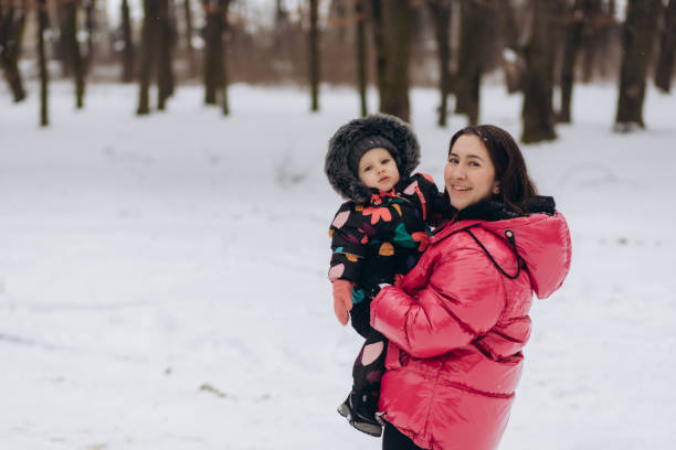 istock Mother with little daughter in a winter forest 2050110184