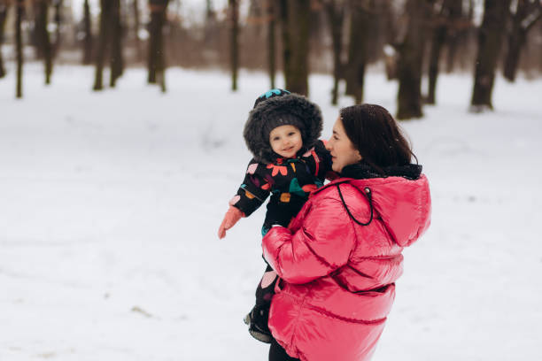 istock Mother with little daughter in a winter forest 2050110195