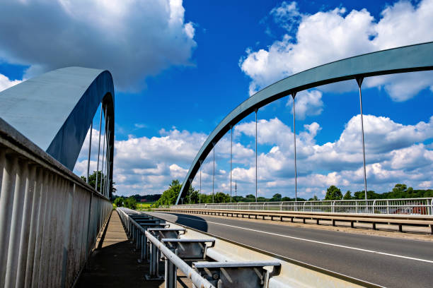 istock Bridge spans over highway against blue sky 2050125923