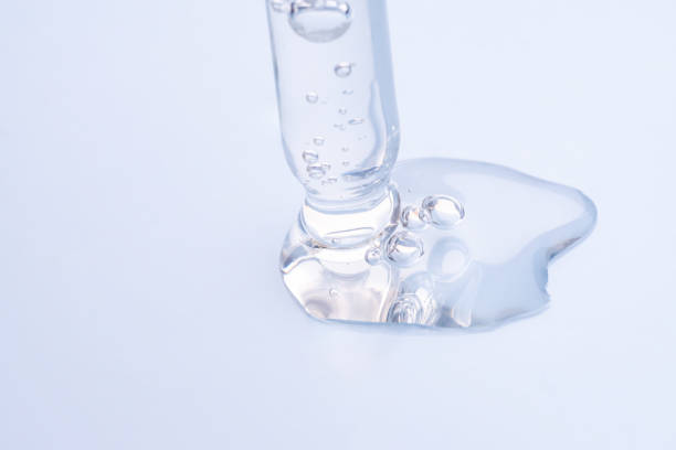 istock Liquid hyaluronic gel or serum on a screen of microscope blue isolated background 2050129111