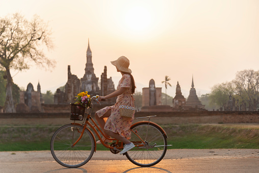 Sukhothai, Thailand Traveler and woman tourist enjoy walking to see the historic park of Thailand.