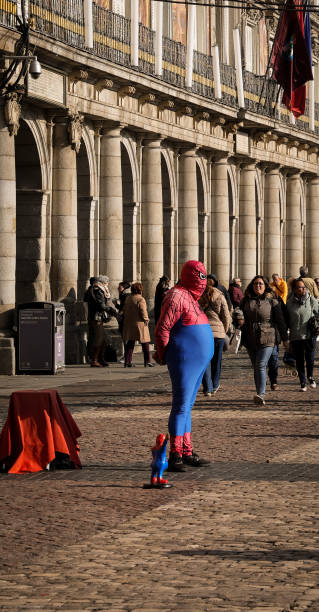 Madrid, Spain – February 04, 2024: The busy Madrid plaza mayor with Spider-Man entertaining crowds