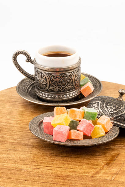 istock Turkish Coffee with Turkish Delight on authentic metal plate, isolated on white background 2050166530