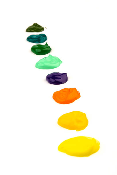 Paint multicolored spots, isolated on white background.Glossy akril paint.Abstract trace shape. Close up.