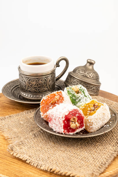 Turkish Coffee with Turkish Delight on authentic metal plate, isolated on white background
