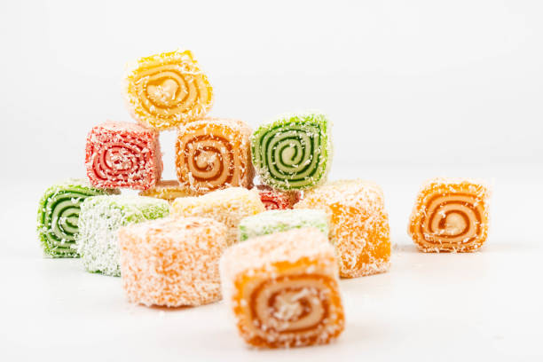 Istanbul Turkey, August 10 2025,This image shows a close-up of colorful gummy candies displayed in bulk.They are coated in sugar crystals, giving them a sparkling, grainy appearance.The candies are piled together in a glass container, probably in a sweet shop or market display.