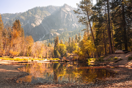 A serene lake surrounded by a colorful autumn mountain landscape