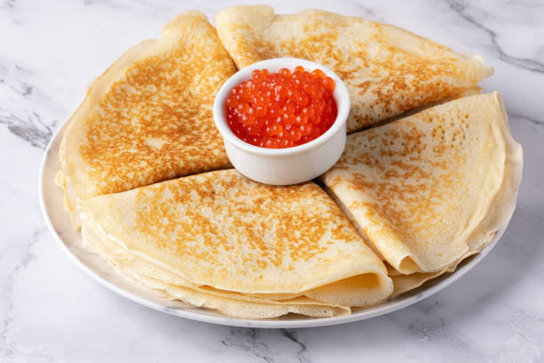 istock Pancakes with red caviar on a marble table 2050178783