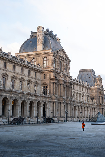 Paris, France – February 26, 2024: A woman in the courtyard of the Louvre Museum