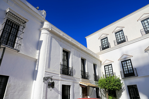 Sanlucar de Barrameda, Cadiz, Spain- October 10, 2023: Beautiful Whitewashed facade of Guzman Palace In Sanlucar de Barrameda