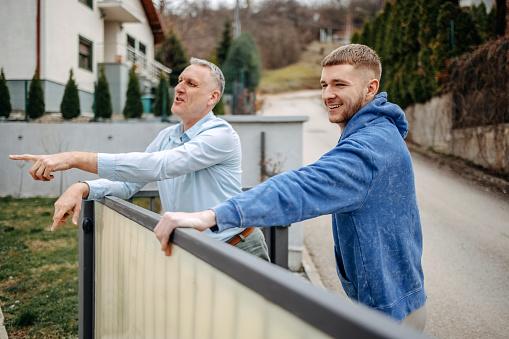 Grown up kid showing to father new house that he bought