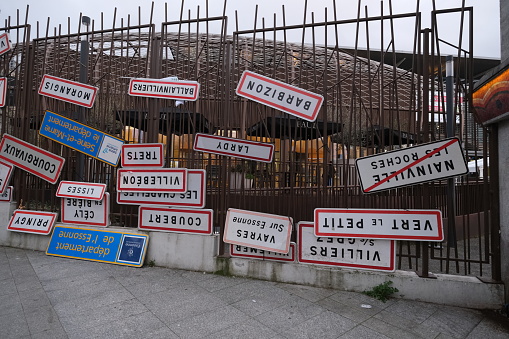 Paris, France - February 28, 2024: Some city signs upside down fixed at the entrance of the metro station during the International Agriculture Fair. An act of protest by the French farmers.