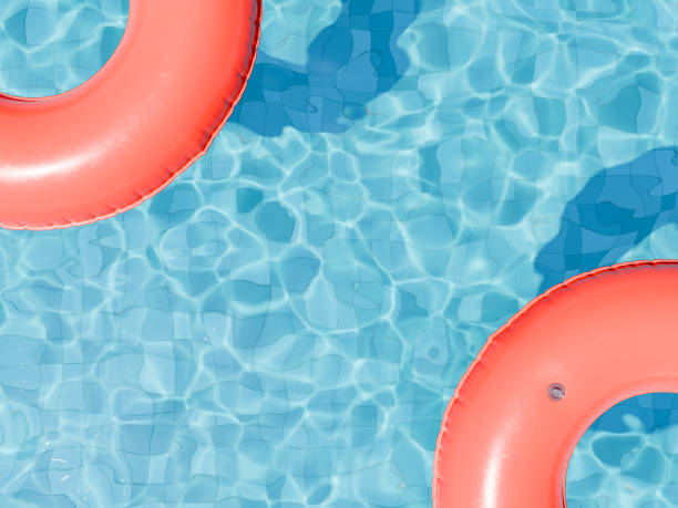 istock Red Swim Rings Floating on Glistening Pool Water 2050202593