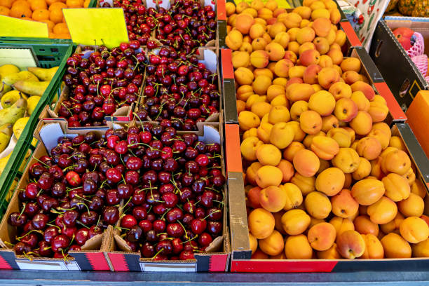 Bunch of fruit that are on display in bins at market.