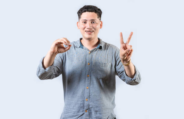 istock Interpreter man gesturing LOVE AND PEACE in sign language isolated. Smiling person making gesture LOVE AND PEACE in sign language 2050210183
