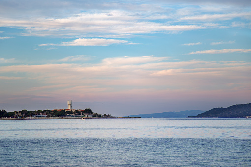 Beautiful seascape with lighthouse at the sunset on the Aegean sea