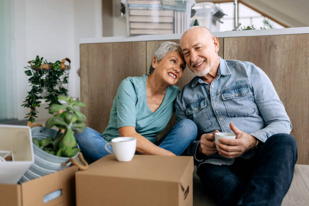 istock Senior couple sitting on a floor while renovating house 2050212915