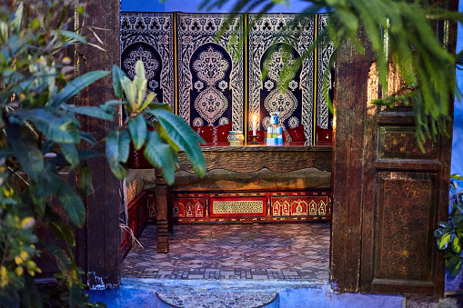 Street side traditional decorated restaurant interior at night in Chefchaouen, Morocco, North Africa.