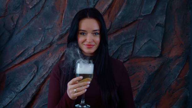 Mature woman with glass of vine enjoying summer afternoon outdoors