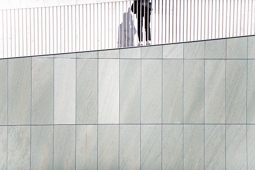 Rear view of a photographer taking a view from the slope of a building