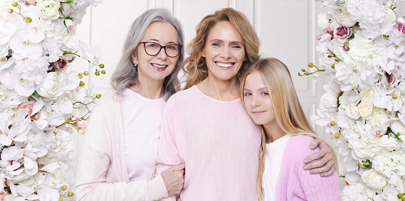 Portrait of grandmother, daughter and granddaughter facing camera smiling very cheerfully - Family concepts