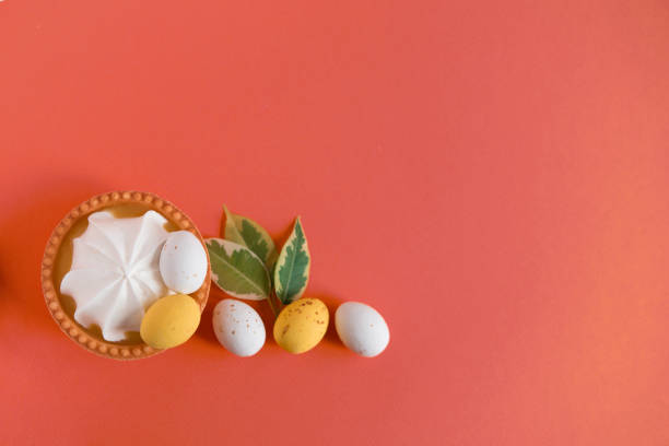 Easter multicolor pastel eggs dessert cake basket with white cream on a colored background. Empty copy space.