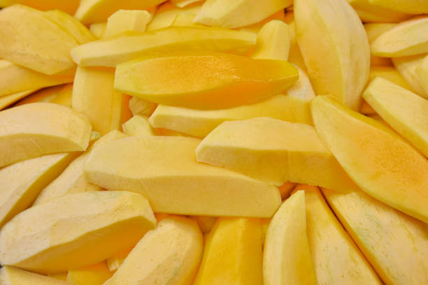 Full frame shot of ripe mango sliced on plate