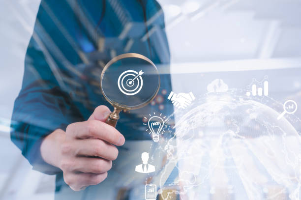 istock business development businessman using Magnifier glass focus to target icon which for planning development leadership and customer target group concept 2050296546