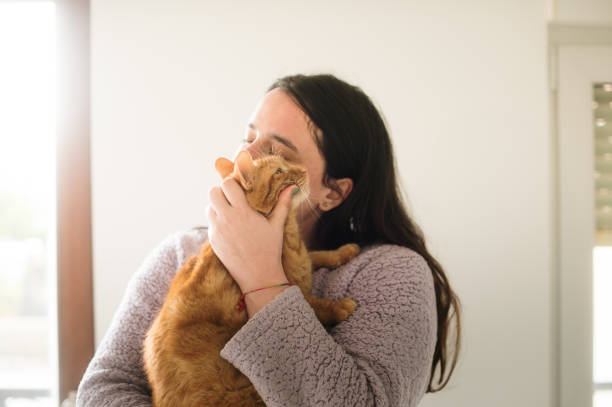 istock Woman embracing a cat 2050300228
