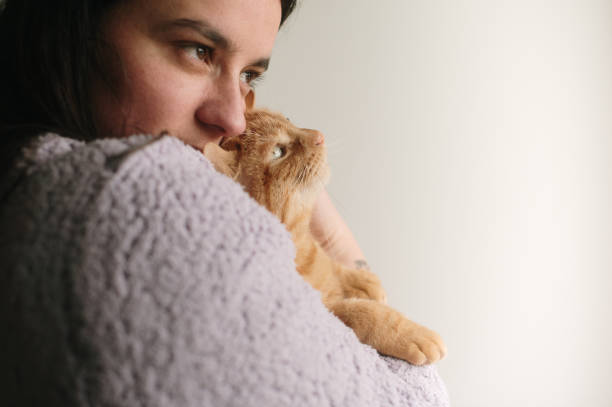 istock Woman with cat in her arms 2050300254
