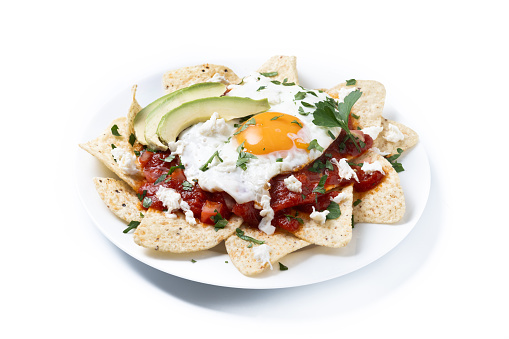 Traditional Mexican breakfast red chilaquiles with egg isolated on white background