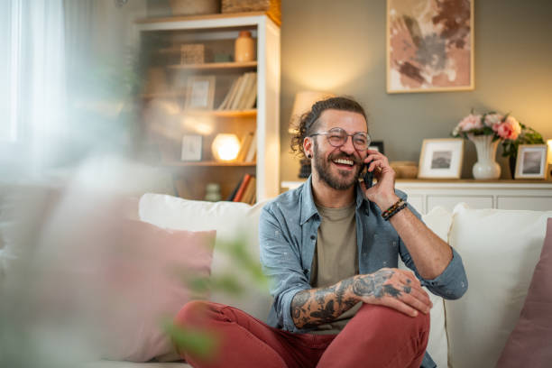 istock Man sitting at home in bed and scrolling social media 2050318659