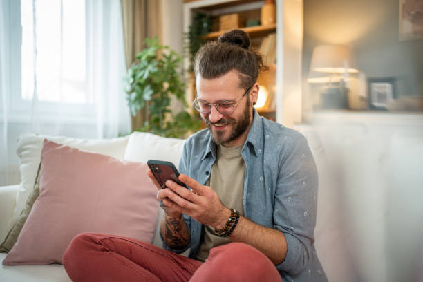 istock Man sitting at home in bed and scrolling social media 2050319175