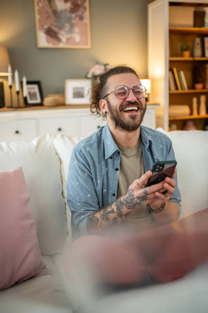 istock Man sitting at home in bed and scrolling social media 2050319176