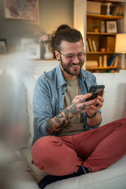istock Man sitting at home in bed and scrolling social media 2050319179