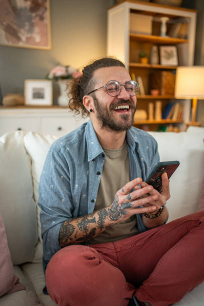 istock Man sitting at home in bed and scrolling social media 2050319181