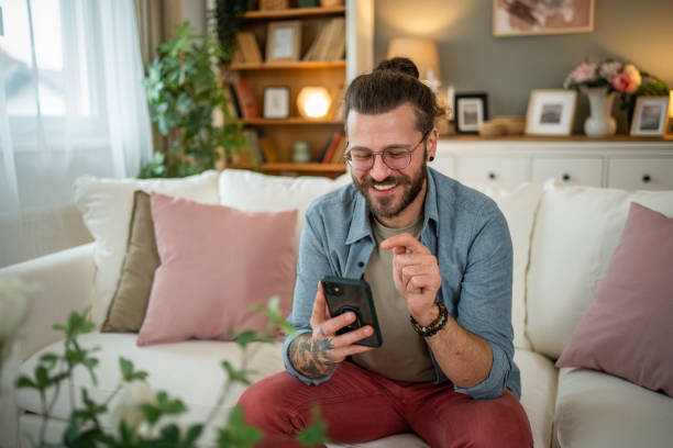 istock Man sitting at home in bed and scrolling social media 2050319184