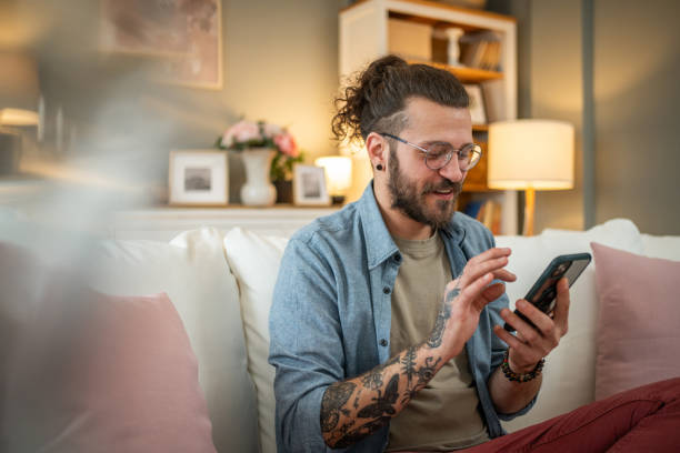 Man sitting at home in bed and scrolling social media