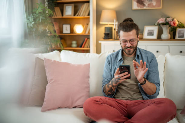 istock Man sitting at home in bed and scrolling social media 2050319196