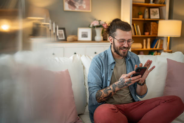 istock Man sitting at home in bed and scrolling social media 2050319230