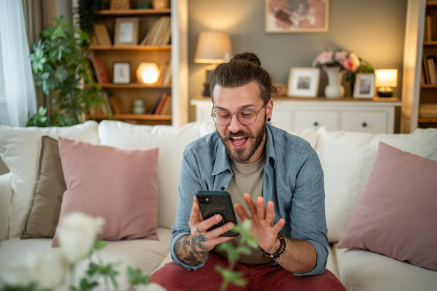 istock Man sitting at home in bed and scrolling social media 2050319714