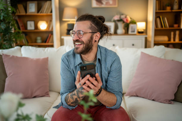istock Man sitting at home in bed and scrolling social media 2050319715