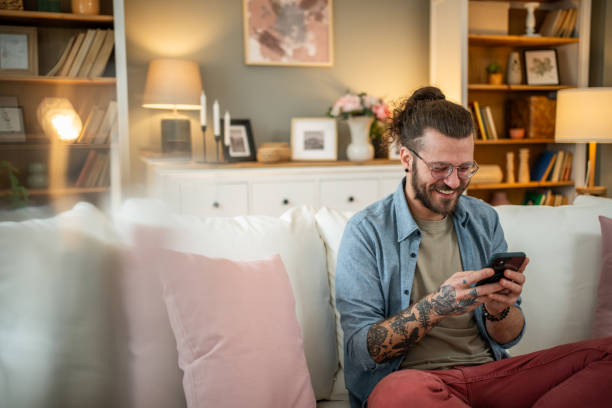 istock Man sitting at home in bed and scrolling social media 2050319741