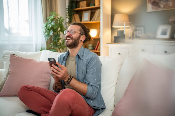 istock Man sitting at home in bed and scrolling social media 2050319744