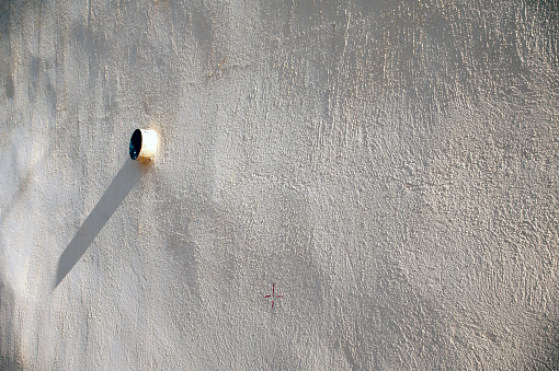 An exhaust pipe from a house with white painted wall in urban area